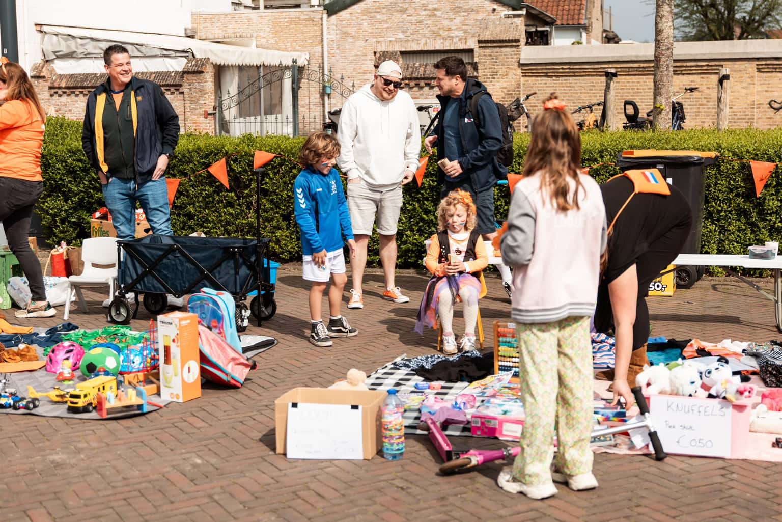 Mensen die spullen verkopen op de vrijmarkt